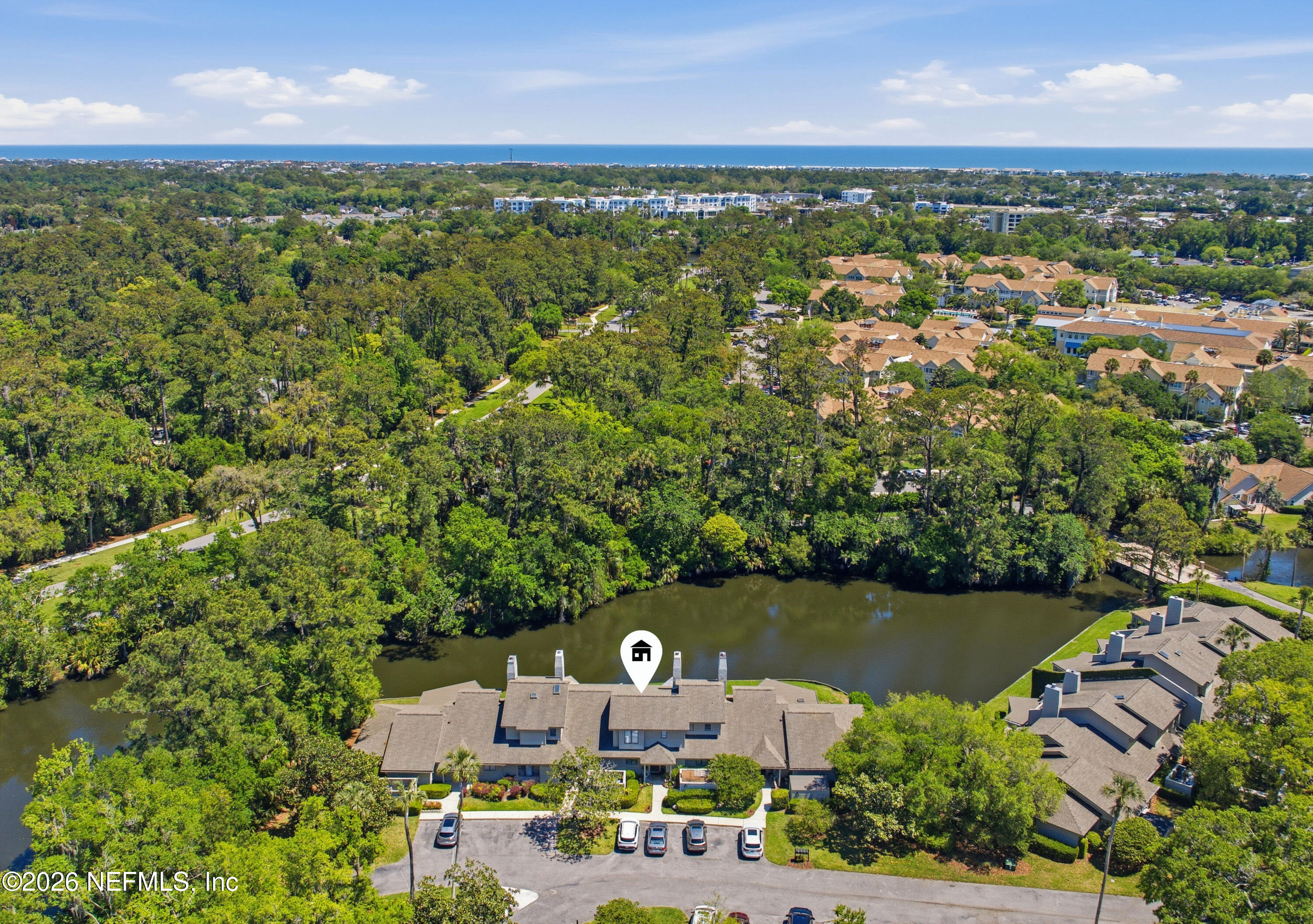 an aerial view of a house with a yard and lake view