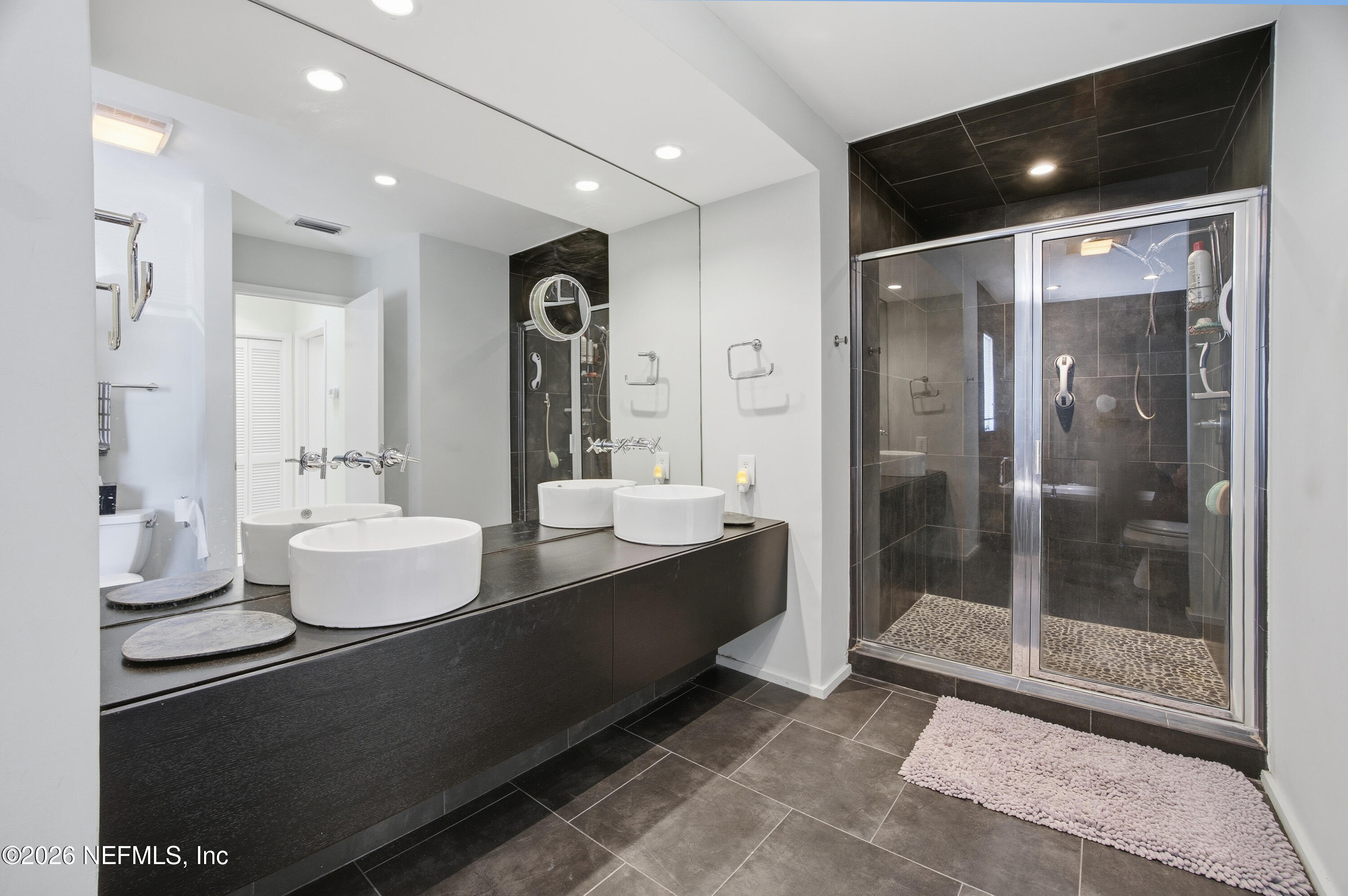 94 Players Club Villas Road Ponte Vedra Beach, FL 32082 - Photo 10 of 25 a bathroom with a double vanity sink mirror and shower