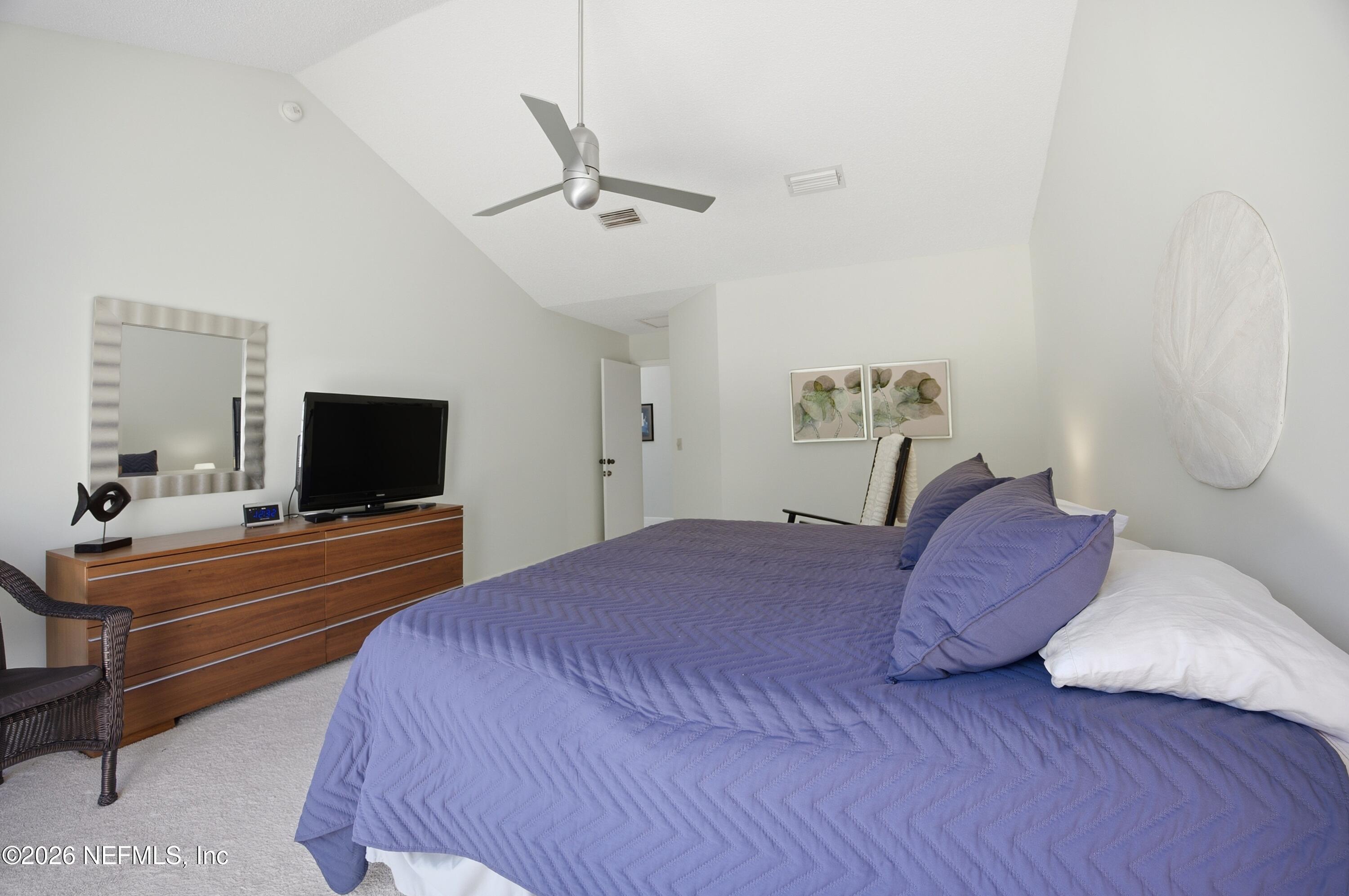 94 Players Club Villas Road Ponte Vedra Beach, FL 32082 - Photo 13 of 25 a bedroom with a bed and a flat screen tv