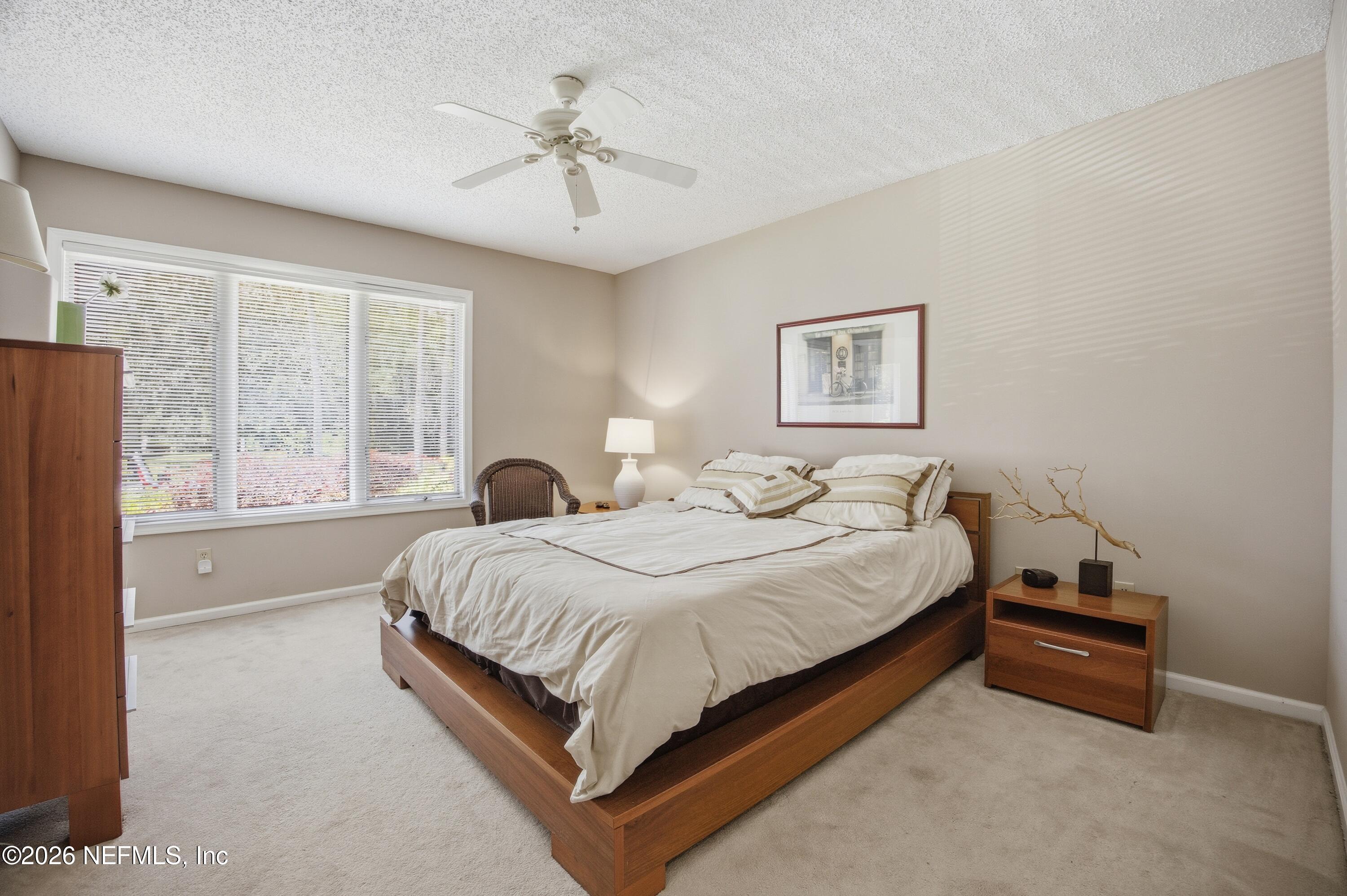 94 Players Club Villas Road Ponte Vedra Beach, FL 32082 - Photo 16 of 25 a spacious bedroom with a bed and a window
