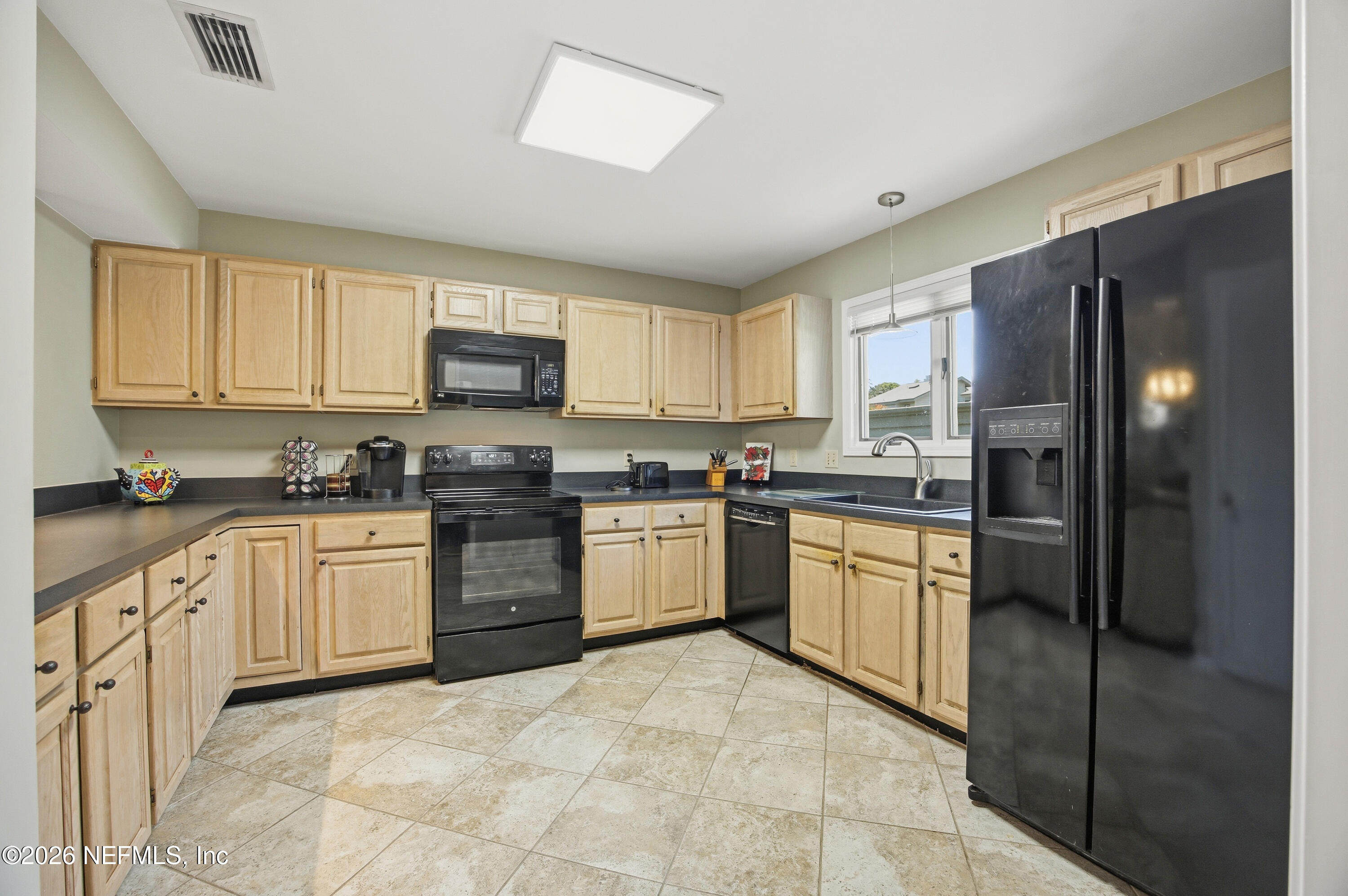 94 Players Club Villas Road Ponte Vedra Beach, FL 32082 - Photo 17 of 25 a kitchen with granite countertop a refrigerator stove top oven and sink
