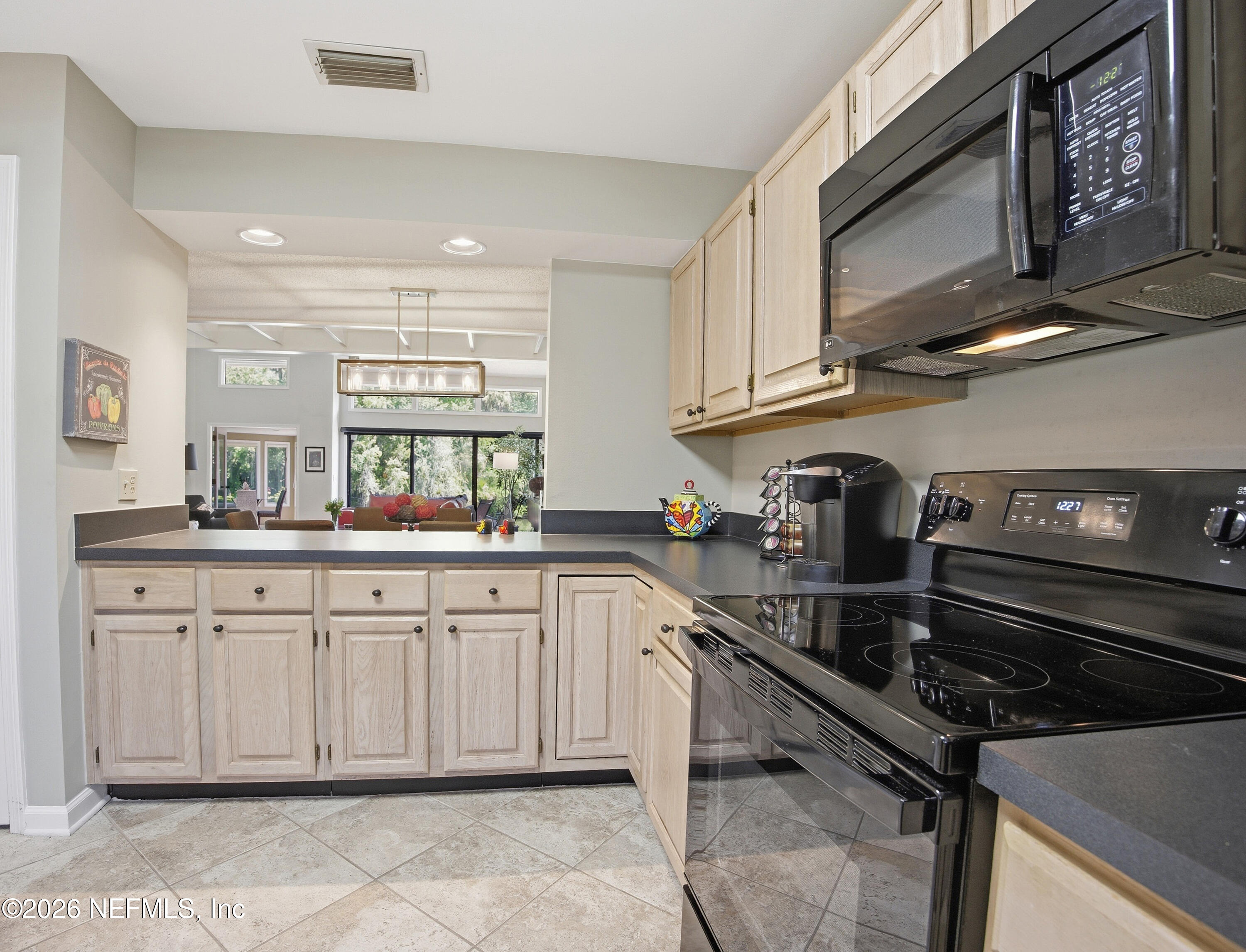 94 Players Club Villas Road Ponte Vedra Beach, FL 32082 - Photo 18 of 25 a kitchen with a sink stove and cabinets
