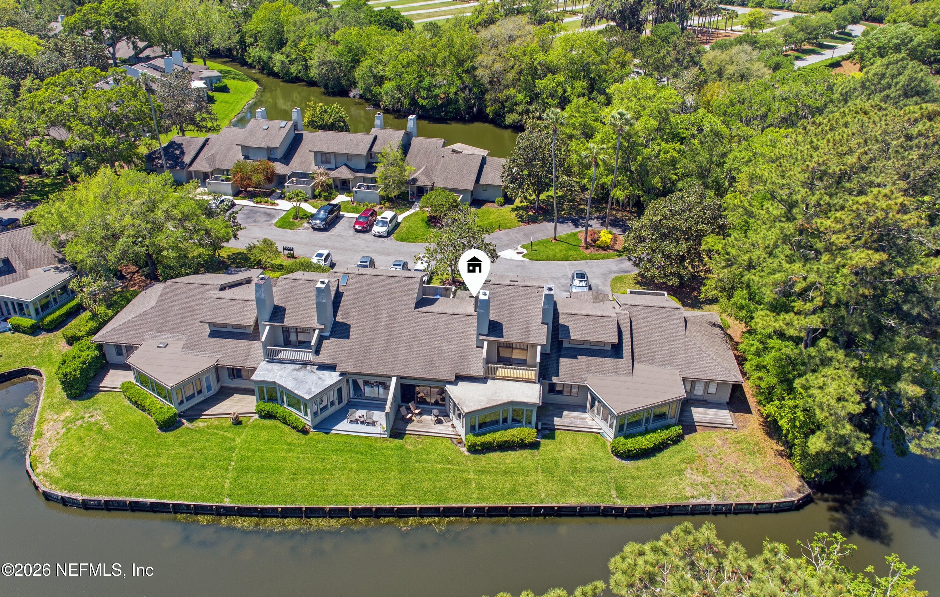 94 Players Club Villas Road Ponte Vedra Beach, FL 32082 - Photo 2 of 25 an aerial view of a house with a garden and lake view