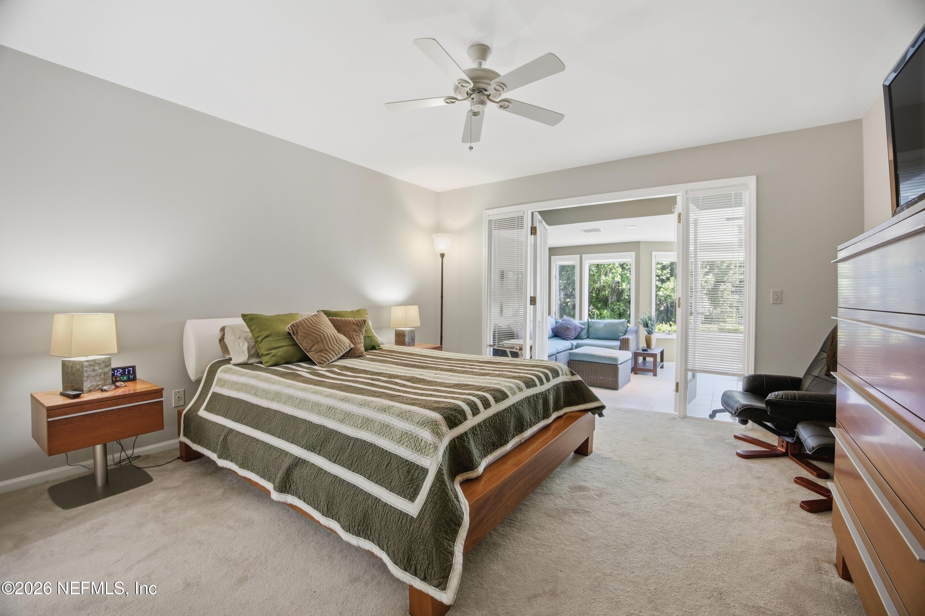 94 Players Club Villas Road Ponte Vedra Beach, FL 32082 - Photo 4 of 25 a spacious bedroom with a bed and a chandelier