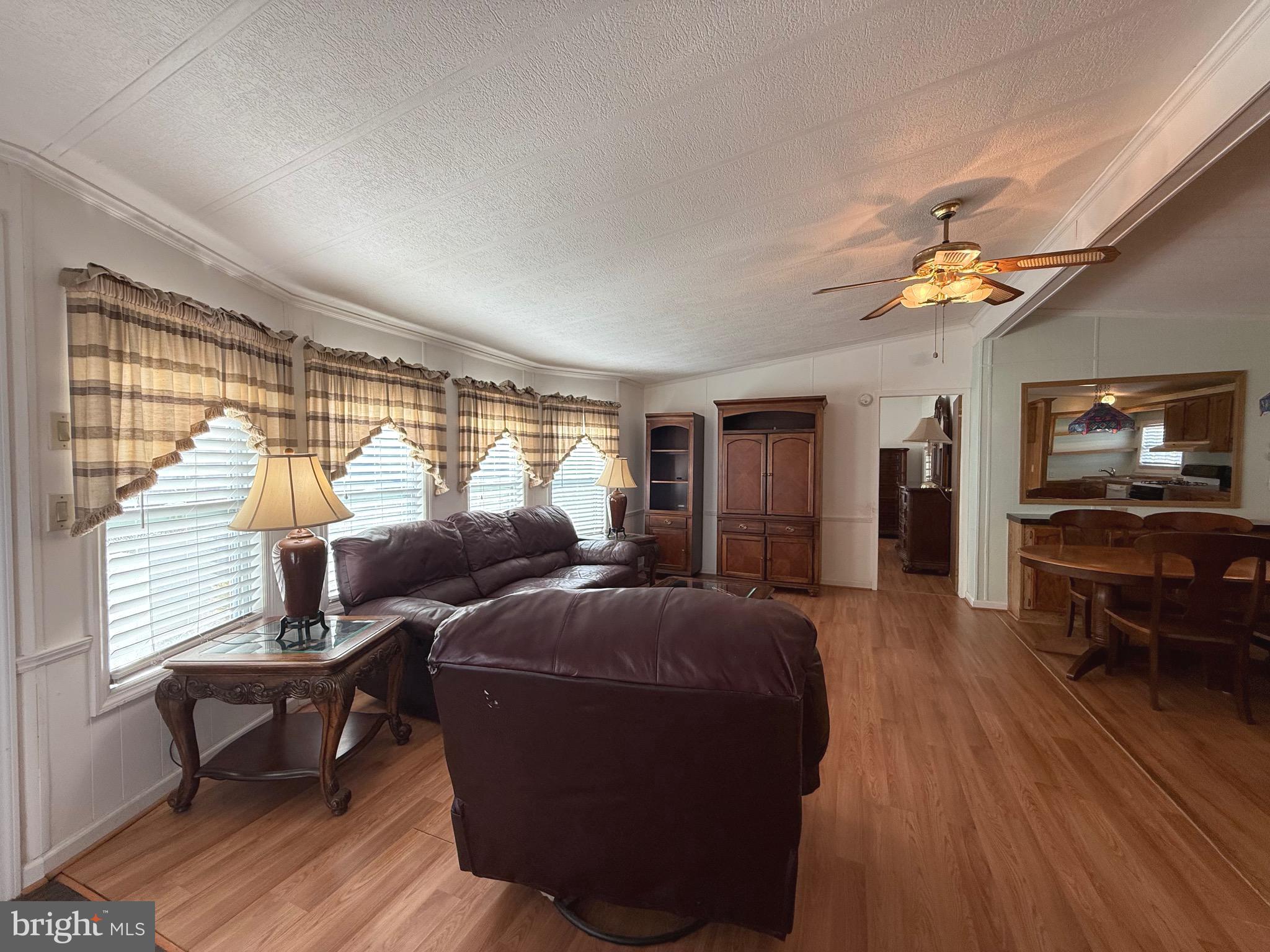 386 Indian Way Buena, NJ 08310 - Photo 12 of 53 a living room with furniture a fireplace and a flat screen tv