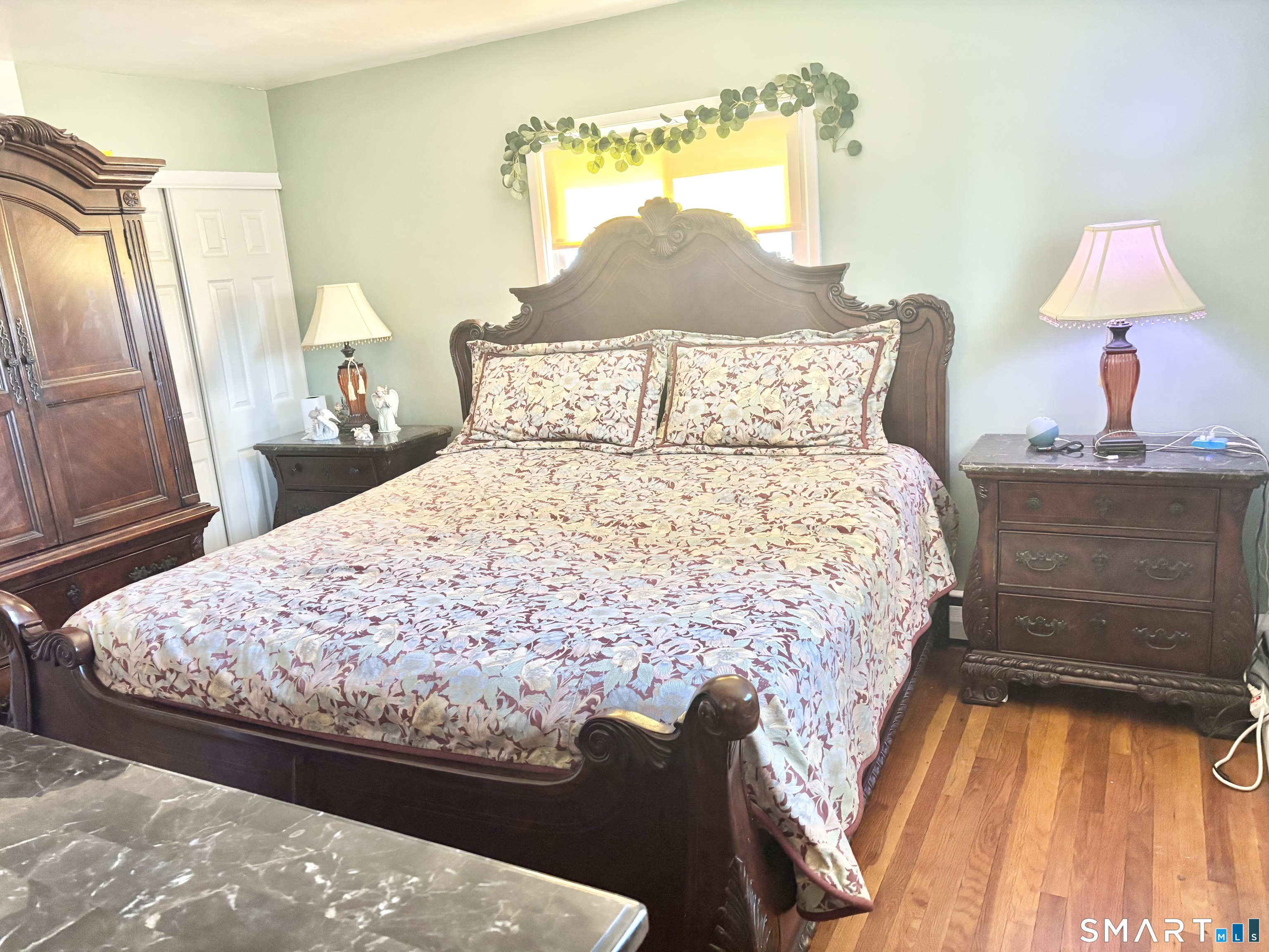 40 Rentschler Street East Hartford, CT 06118 - Photo 7 of 14 a bed sitting in a bedroom next to a window with lamp