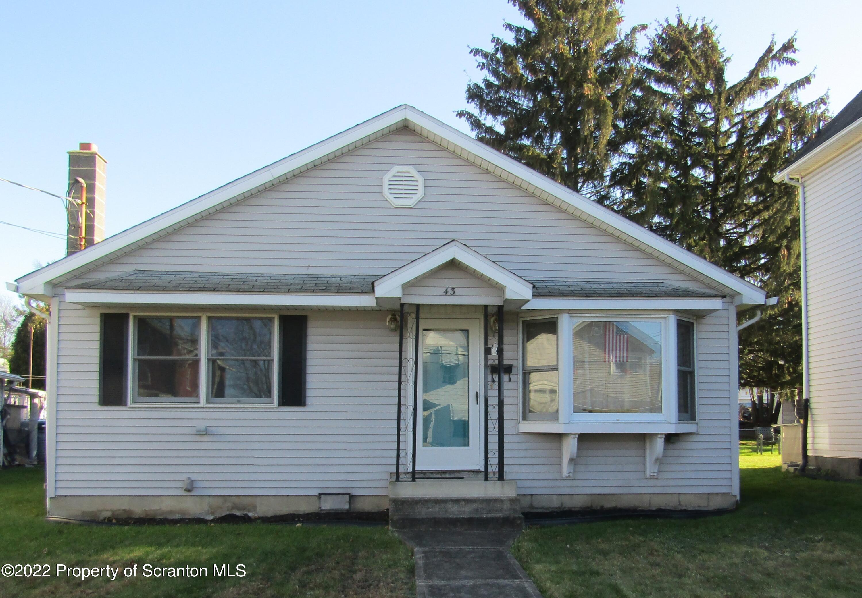 43 Prospect Street Pittston, PA 18640 - Photo 1 of 32 a front view of a house with a garden