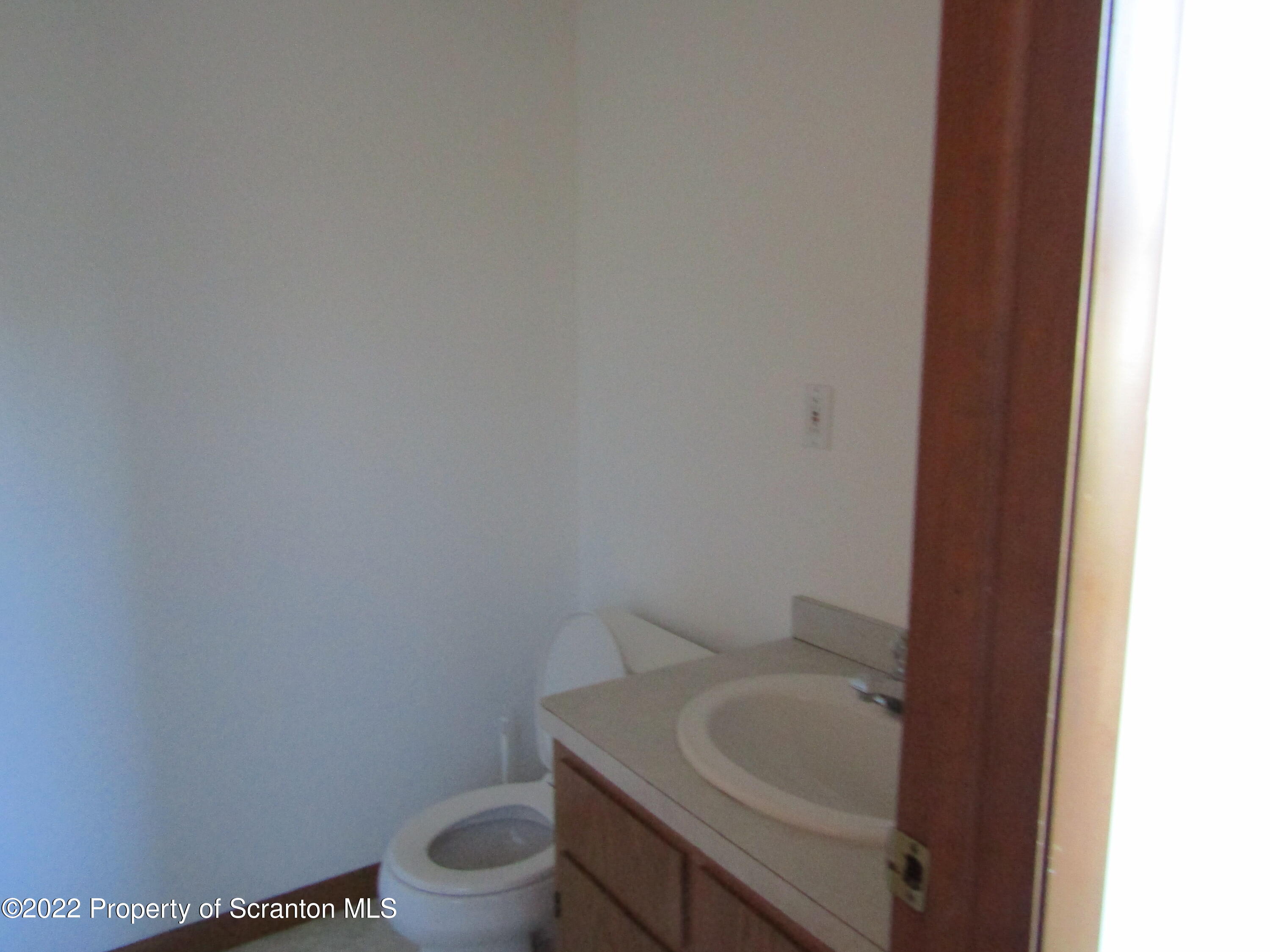 43 Prospect Street Pittston, PA 18640 - Photo 15 of 32 a bathroom with a sink a toilet and a mirror