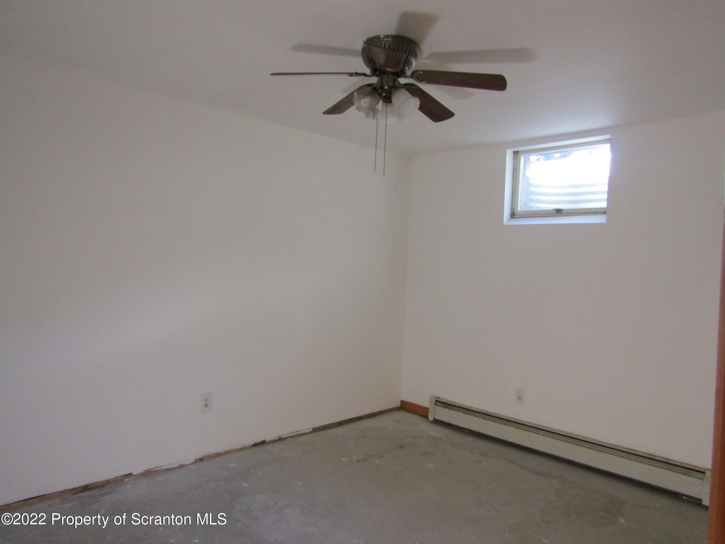 43 Prospect Street Pittston, PA 18640 - Photo 21 of 32 an empty room with a window and a fan