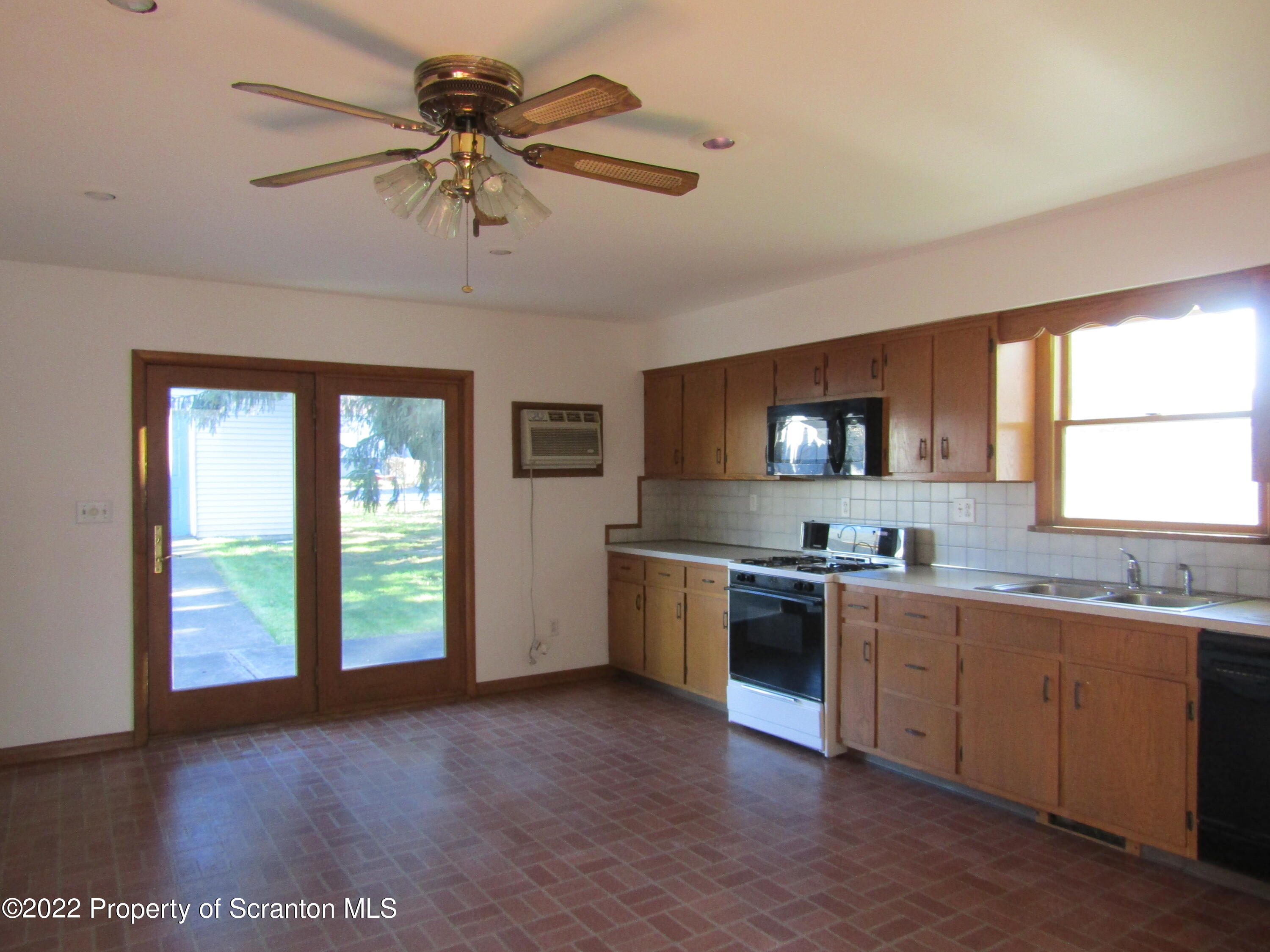 43 Prospect Street Pittston, PA 18640 - Photo 7 of 32 a kitchen with a stove a sink and a refrigerator