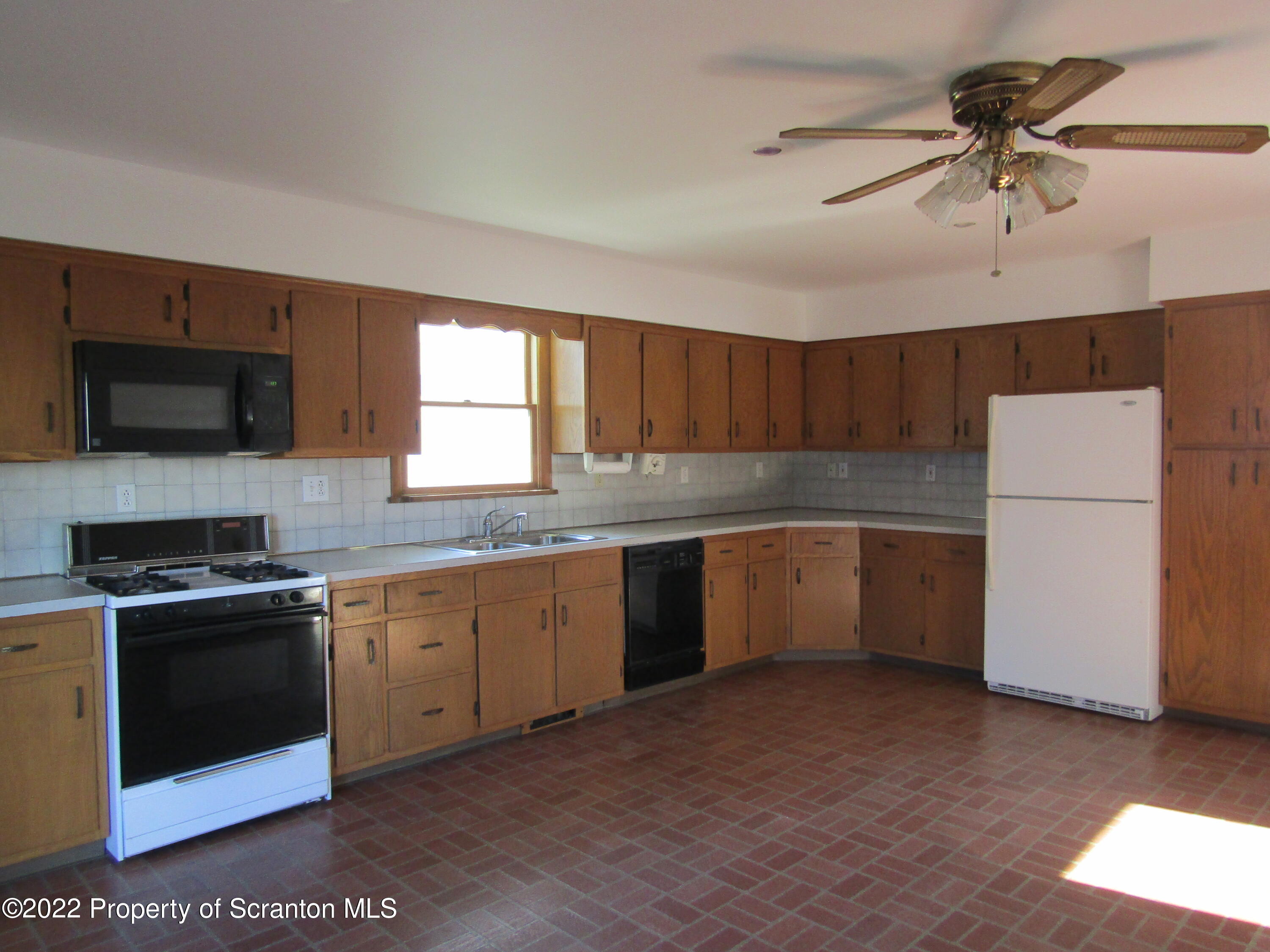 43 Prospect Street Pittston, PA 18640 - Photo 8 of 32 a kitchen with granite countertop a sink stainless steel appliances and counter space