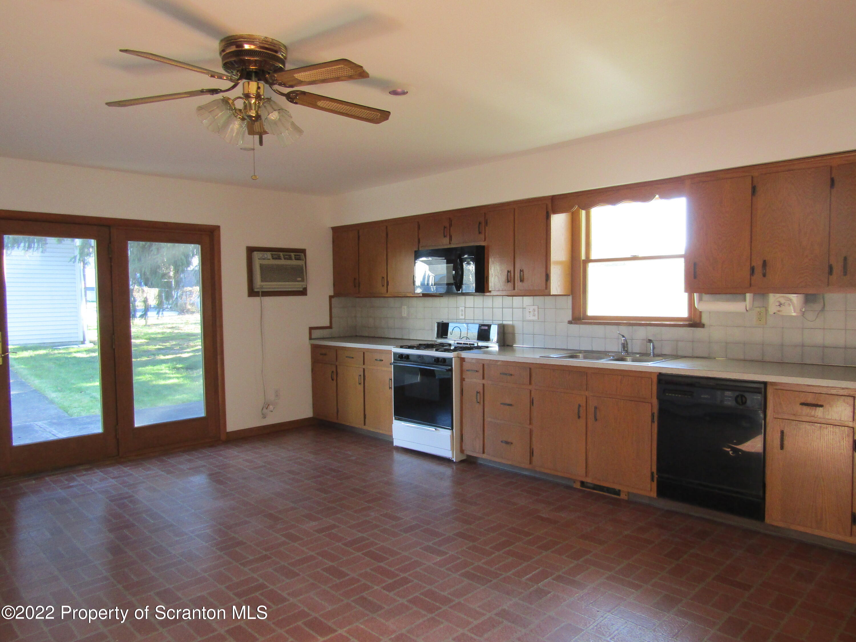 43 Prospect Street Pittston, PA 18640 - Photo 9 of 32 a kitchen with a stove a sink and a microwave