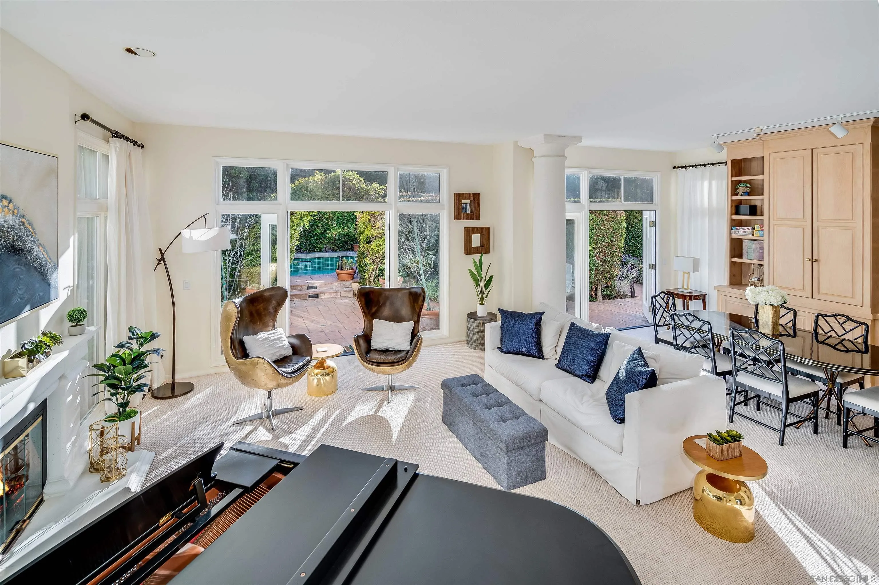9636 Claiborne Square La Jolla, CA 92037 - Photo 14 of 48 a living room with furniture fireplace and large windows