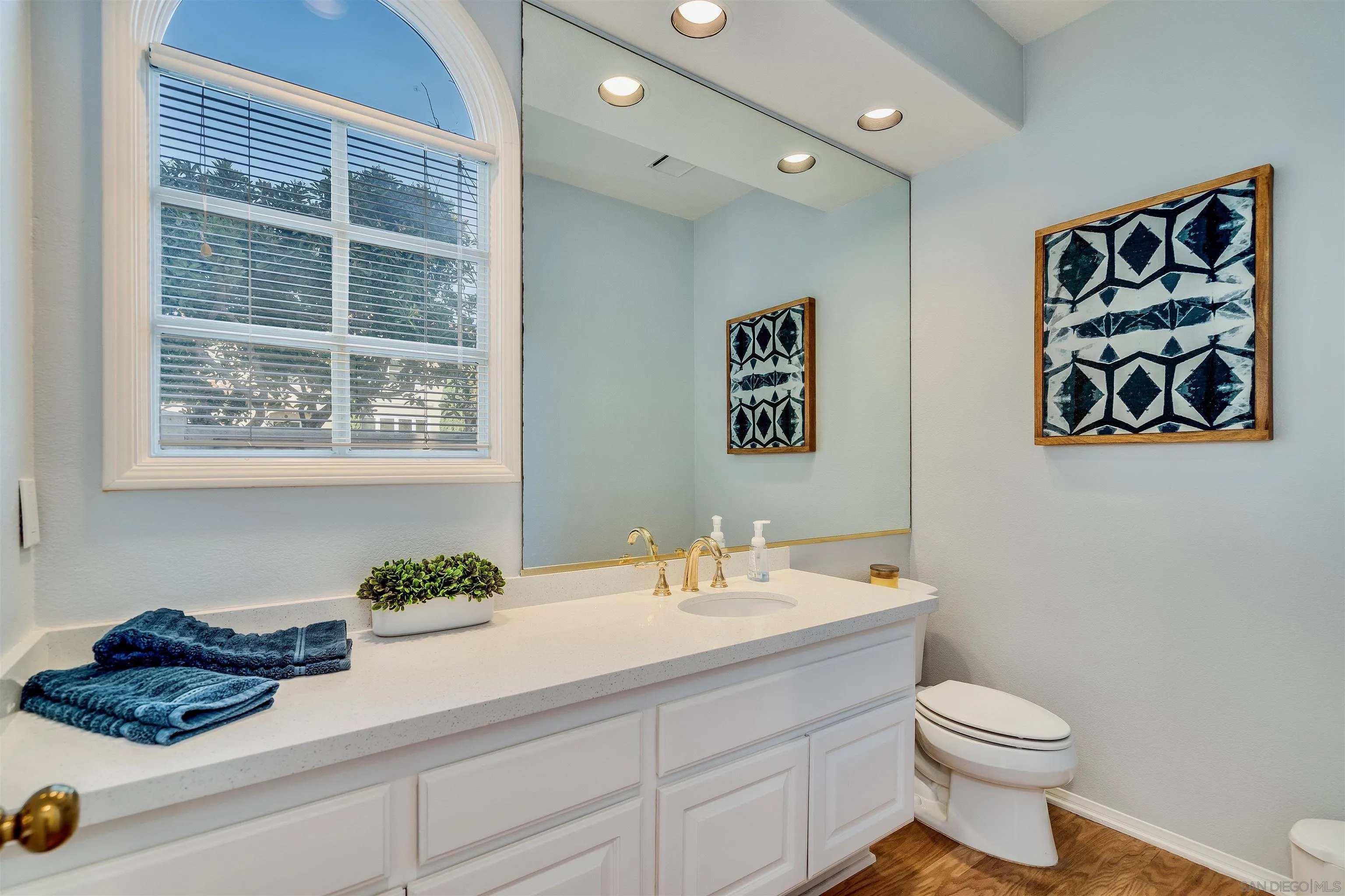 9636 Claiborne Square La Jolla, CA 92037 - Photo 16 of 48 a bathroom with a sink a toilet and a mirror