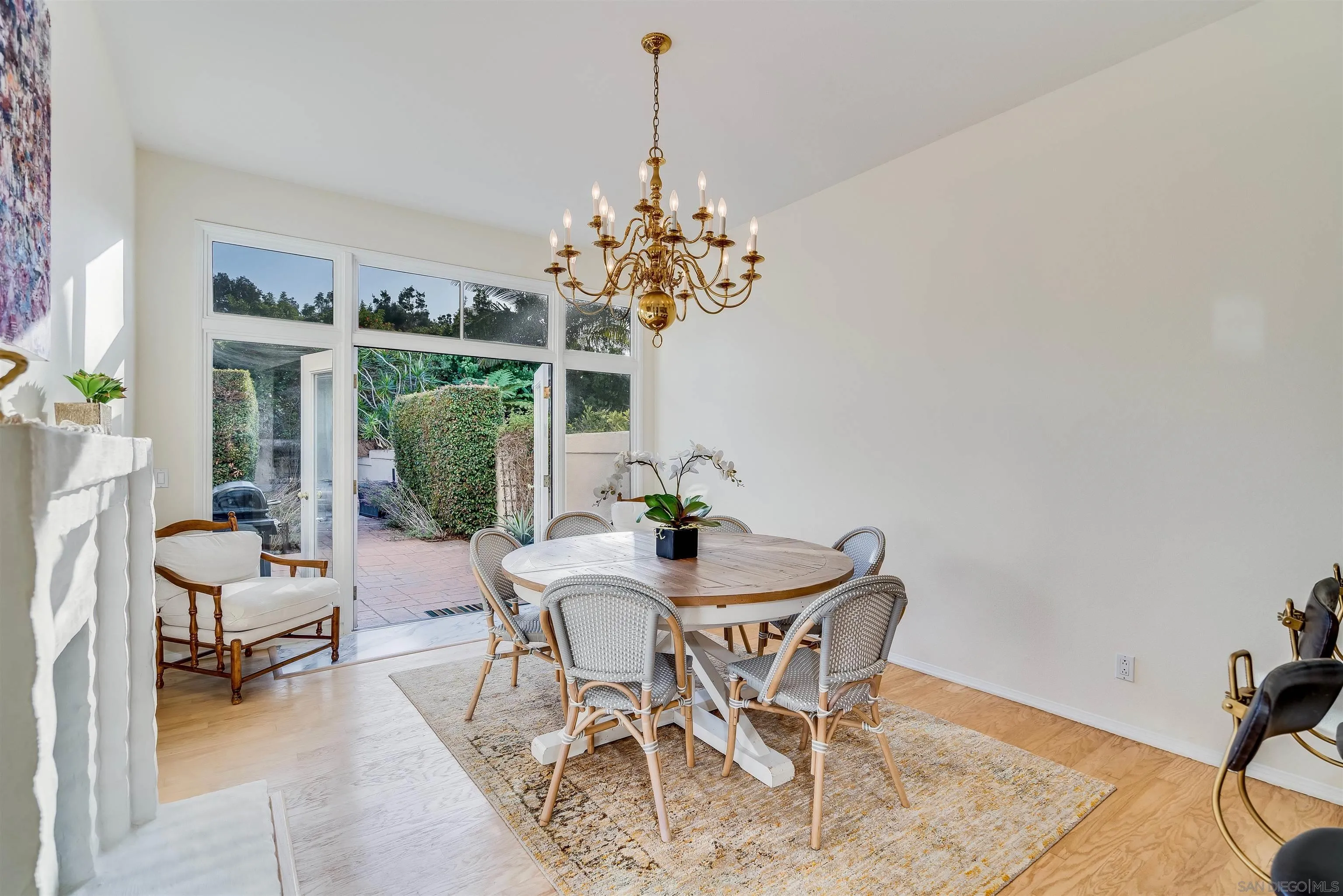 9636 Claiborne Square La Jolla, CA 92037 - Photo 19 of 48 a dining room with furniture and a chandelier