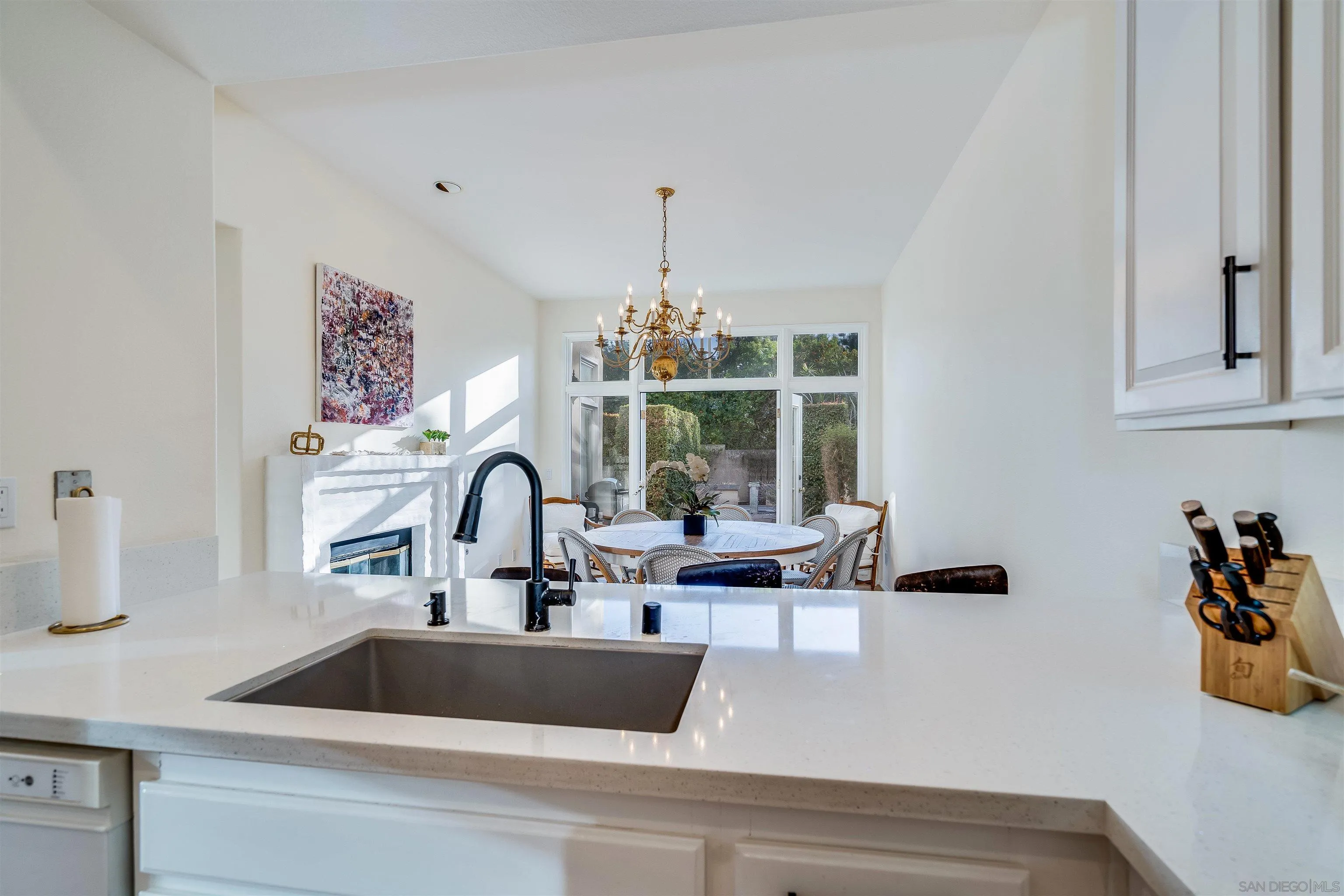 9636 Claiborne Square La Jolla, CA 92037 - Photo 22 of 48 a kitchen with a faucet a sink and cabinets