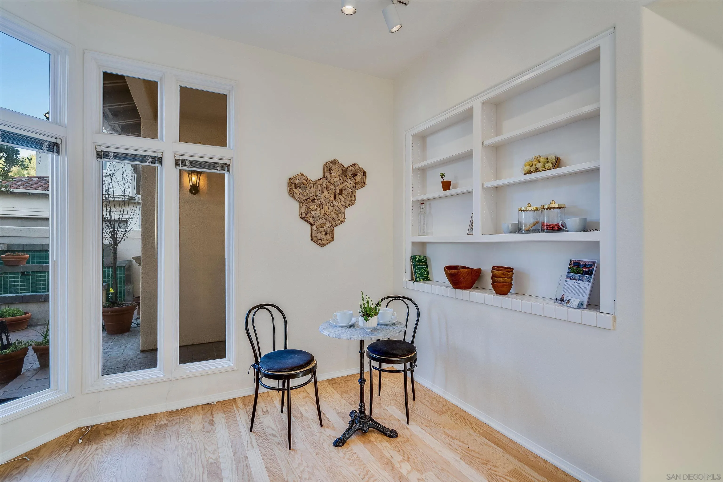 9636 Claiborne Square La Jolla, CA 92037 - Photo 23 of 48 a view of a workspace with furniture and wooden floor