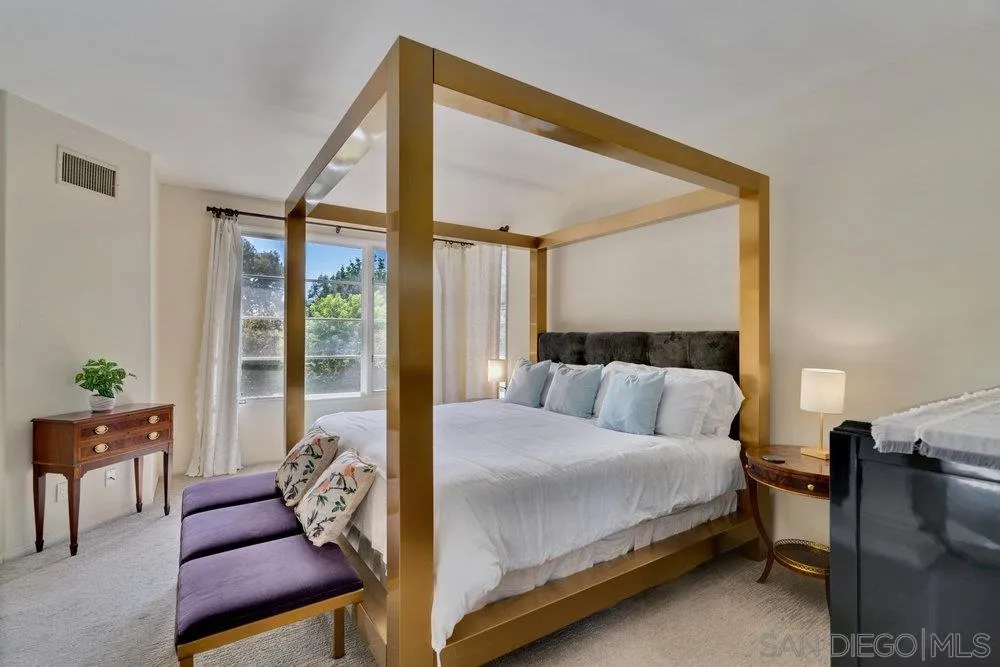 9636 Claiborne Square La Jolla, CA 92037 - Photo 24 of 48 a bedroom with a bed and a couch