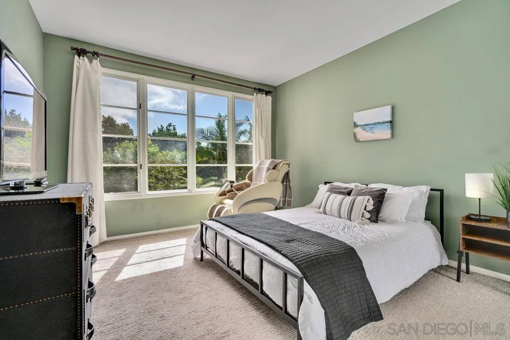 9636 Claiborne Square La Jolla, CA 92037 - Photo 30 of 48 a bedroom with a bed and a large window