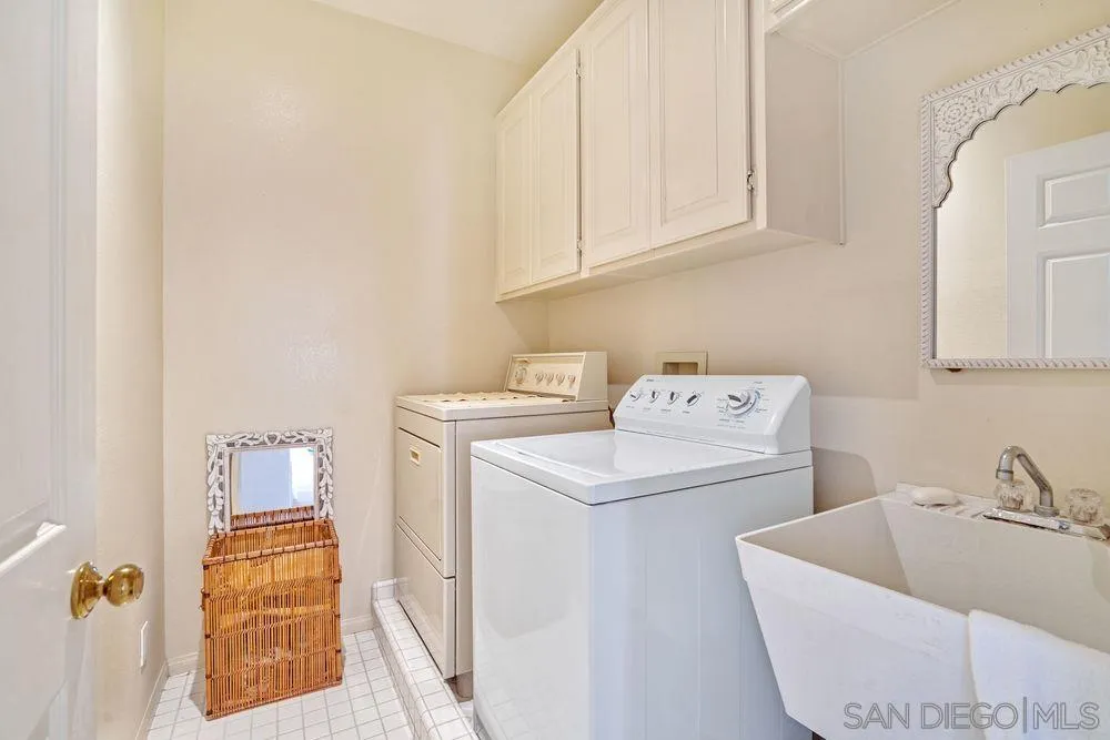 9636 Claiborne Square La Jolla, CA 92037 - Photo 35 of 48 a utility room with a sink washer and dryer