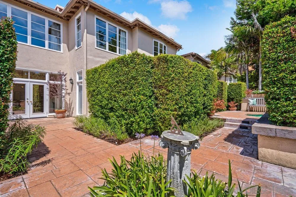 9636 Claiborne Square La Jolla, CA 92037 - Photo 40 of 48 a view of a house with a yard and potted plants