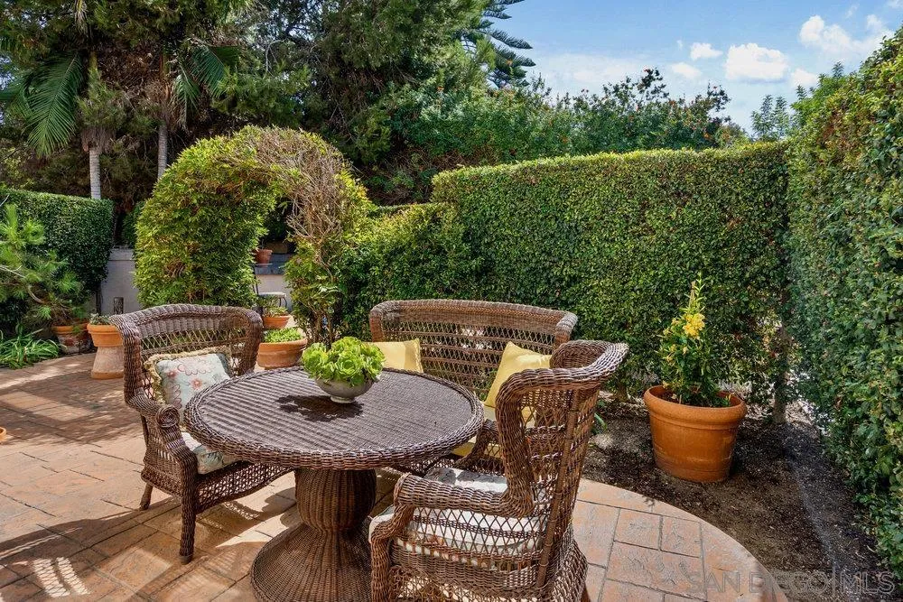 9636 Claiborne Square La Jolla, CA 92037 - Photo 42 of 48 a view of a patio with table and chairs and potted plants