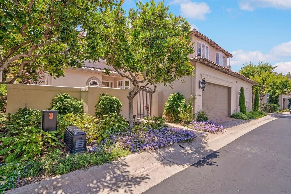 9636 Claiborne Square La Jolla, CA 92037 - Photo 5 of 48 a front view of a house with garden