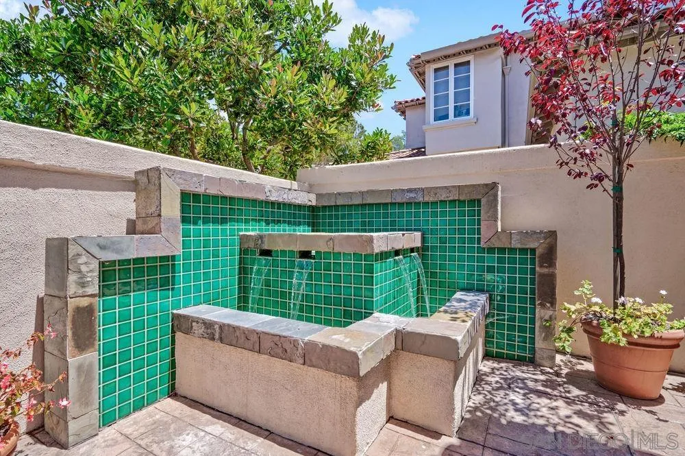 9636 Claiborne Square La Jolla, CA 92037 - Photo 7 of 48 a view of a chair and table in the backyard