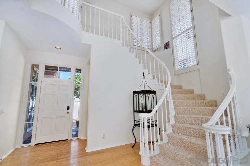 9636 Claiborne Square La Jolla, CA 92037 - Photo 9 of 48 a view of entryway with wooden floor and stairs