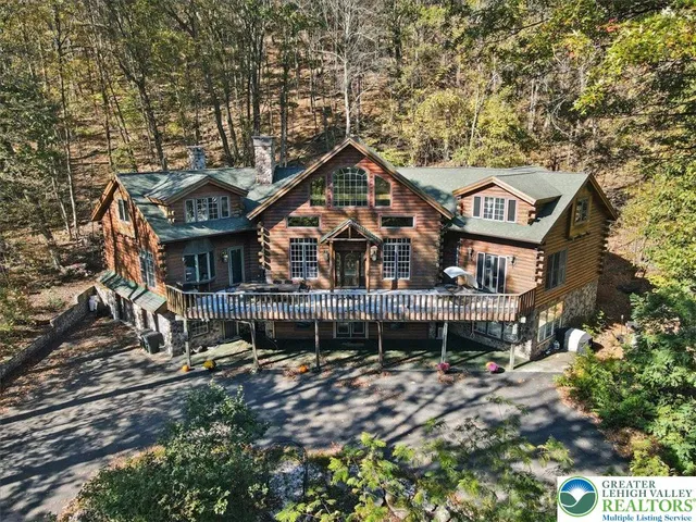 a living room with furniture and large windows