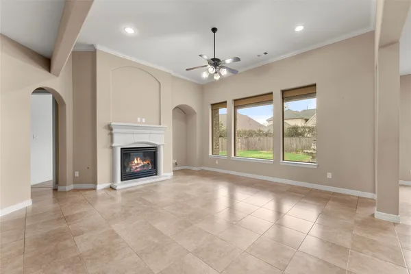 a view of an empty room with a fireplace and a window