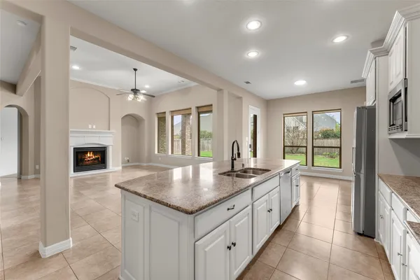 a open kitchen with granite countertop a sink and dishwasher with a large window