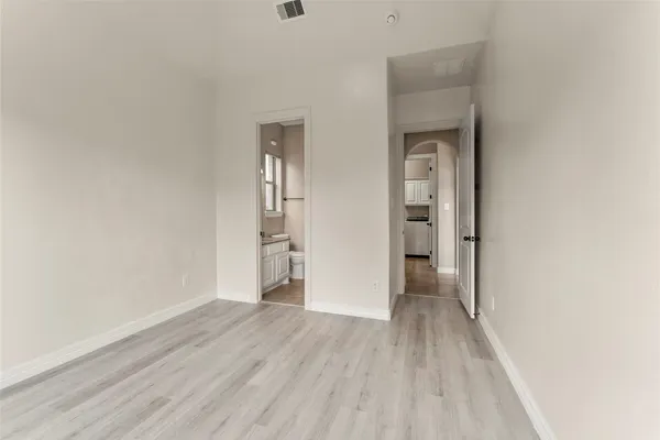 a view of hallway with wooden floor