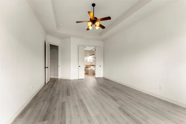 a view of an empty room and wooden floor