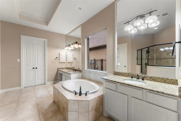 a bathroom with a granite countertop sink a toilet a mirror and vanity