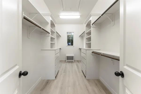 a view of a livingroom with wooden floor and staircase