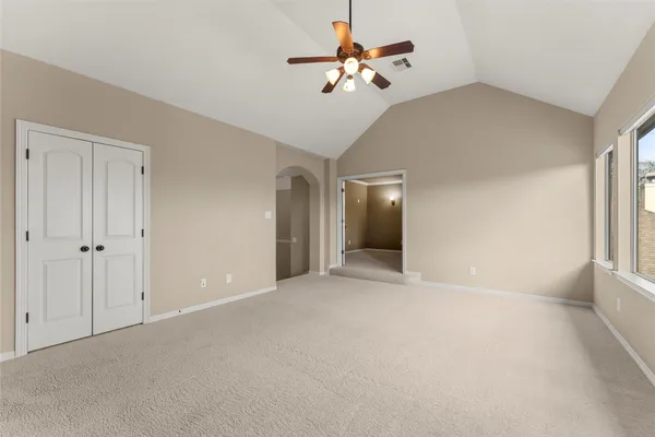 a view of an empty room with a ceiling fan