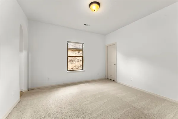 a bathroom with a sink vanity mirror and toilet