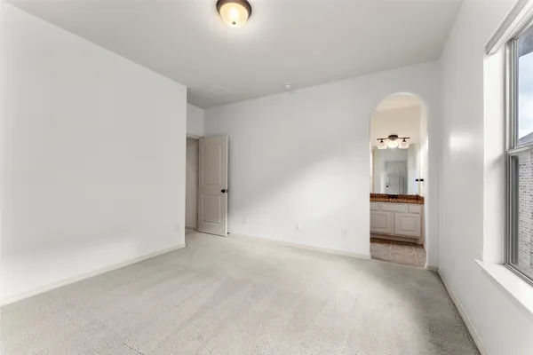 a bathroom with a granite countertop sink a toilet and a mirror