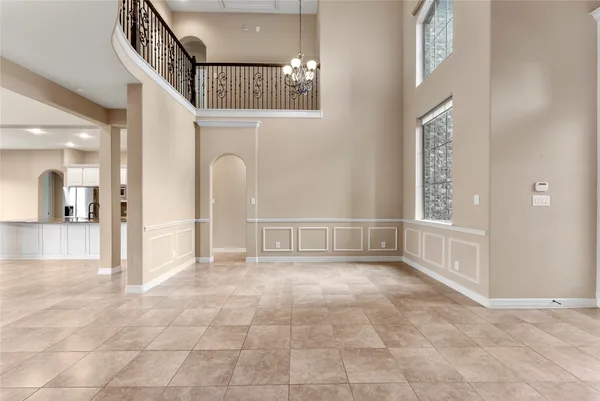 a view of a hallway with entryway and chandelier