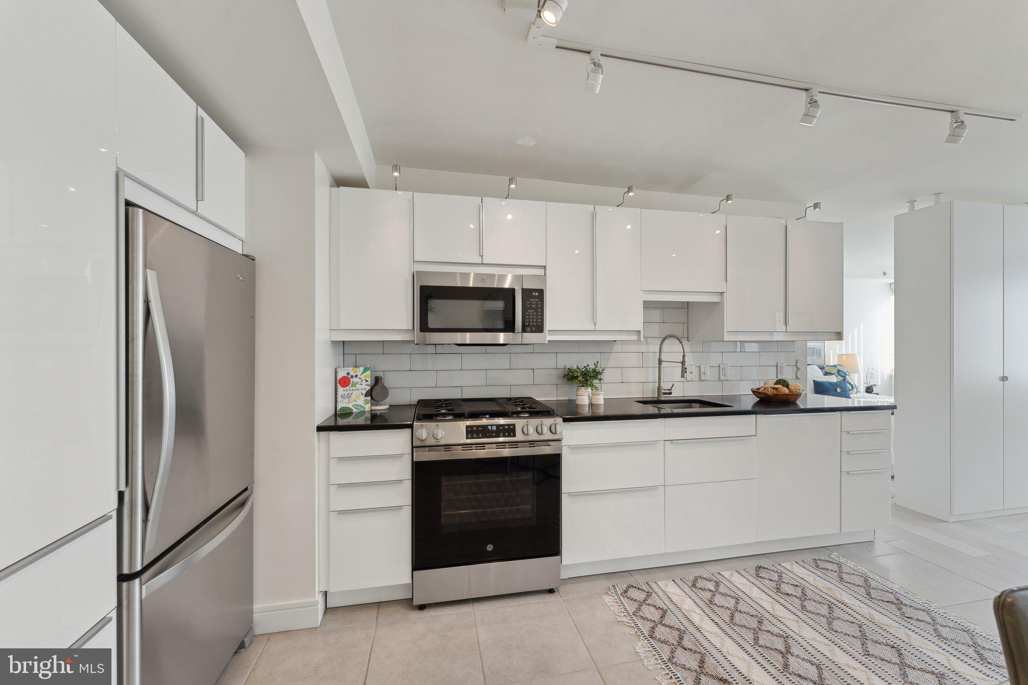 800 4th Street Southwest, Unit S419 Washington, DC 20024 - Photo 18 of 32 a kitchen with stainless steel appliances granite countertop a refrigerator and a stove top oven