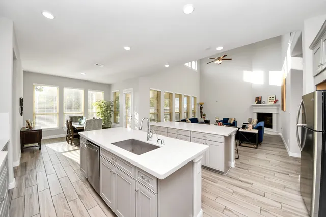 a view of living room kitchen with a sink and refrigerator