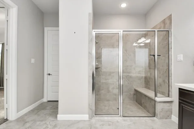 a bathroom with a glass shower door