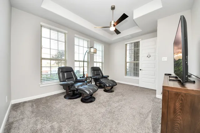 a living room with furniture tv and a large window