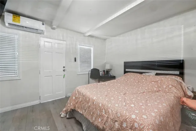 a bedroom with a bed and window