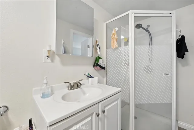 a bathroom with a sink vanity and mirror