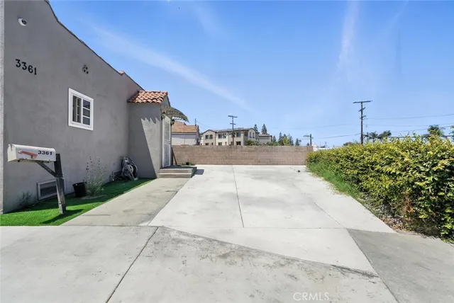 a view of a street with cars parked in front of it