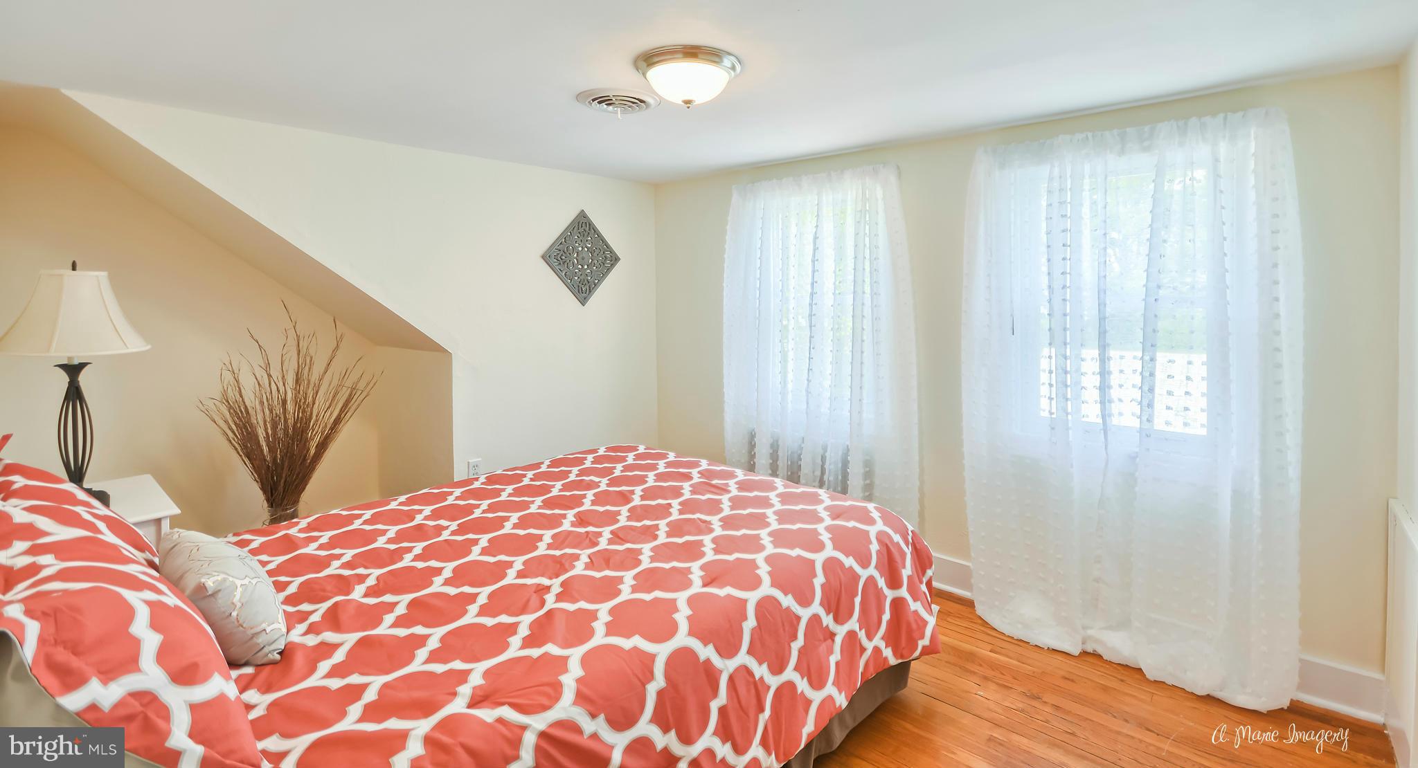 1651 Shookstown Road Frederick, MD 21702 - Photo 13 of 30 a bedroom with a large bed and a chandelier
