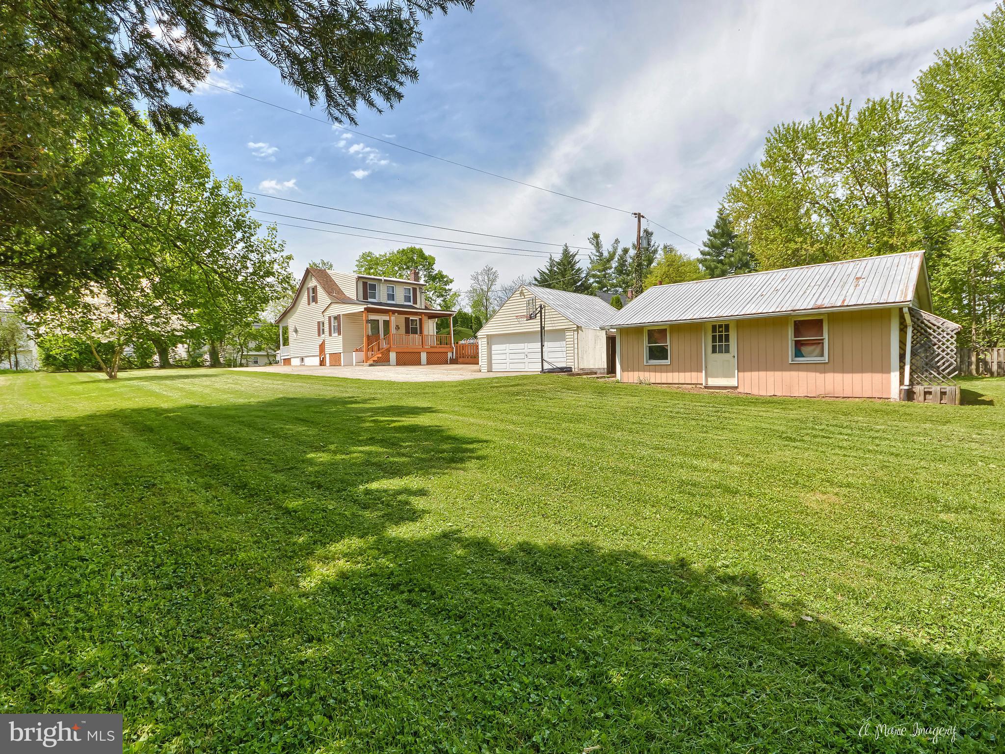 1651 Shookstown Road Frederick, MD 21702 - Photo 25 of 30 a view of a white house with a big yard and large trees