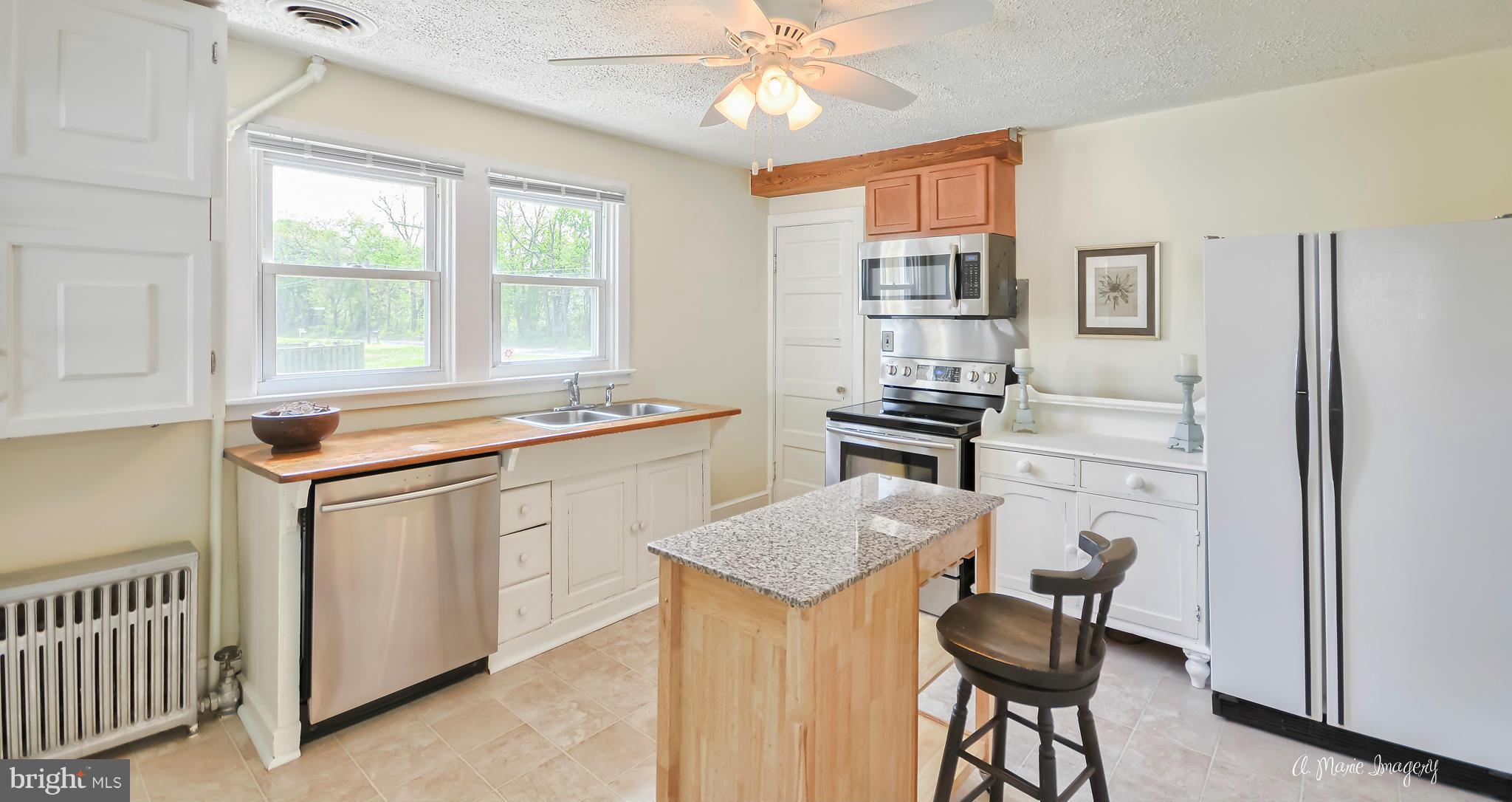 1651 Shookstown Road Frederick, MD 21702 - Photo 7 of 30 a kitchen with stainless steel appliances granite countertop a stove a sink and a refrigerator